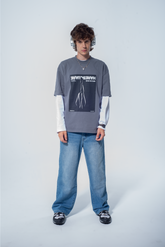 Model in the Haresquare Steel Grey tshirt with a bold graphic print, styled with Haresquare denim jeans in blue – unisex luxury streetwear from Ireland.